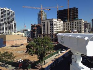 small side view of construction camera with construction site in the distance