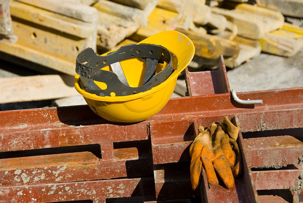 View-of-hard-hat-and-gloves-at-construction-site-89887971_3000x2008