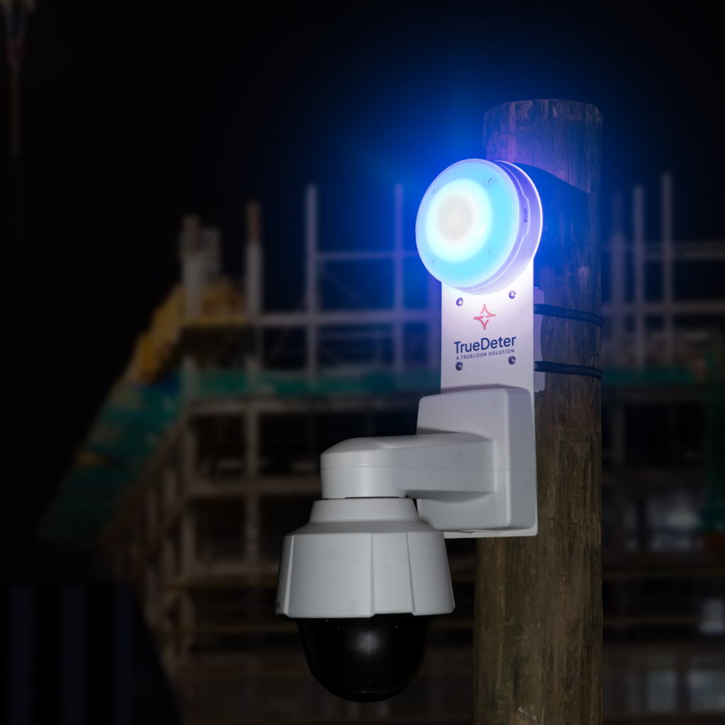 A TrueDeter PTZ Unit with a camera and strobe mounted to a pole monitoring a jobsite while the blue strobe link blinks