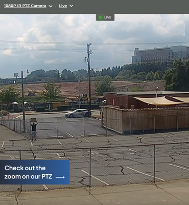 An image of a parking lot and construction site captured by a construction camera
