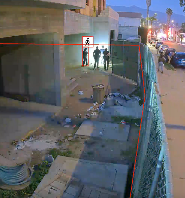 Cops arresting a trespasser on a construction site after a construction camera caught them