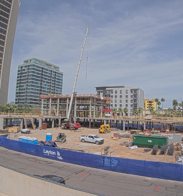 steel beams being erected to start construction of the Hilton Park Central hotel. It is an active construction site and captured by a camera.
