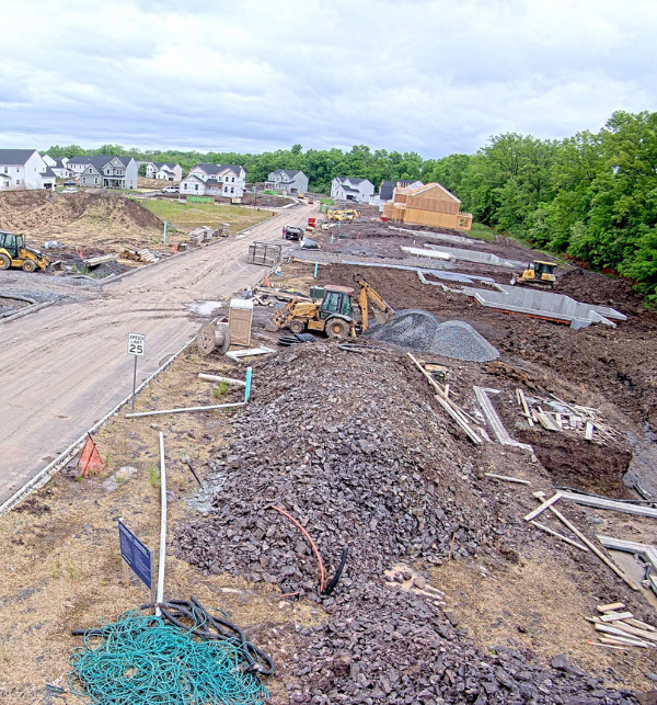 A construction camera photo of multiple homes being framed and built
