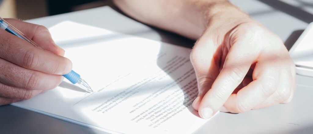 Hand signing a document