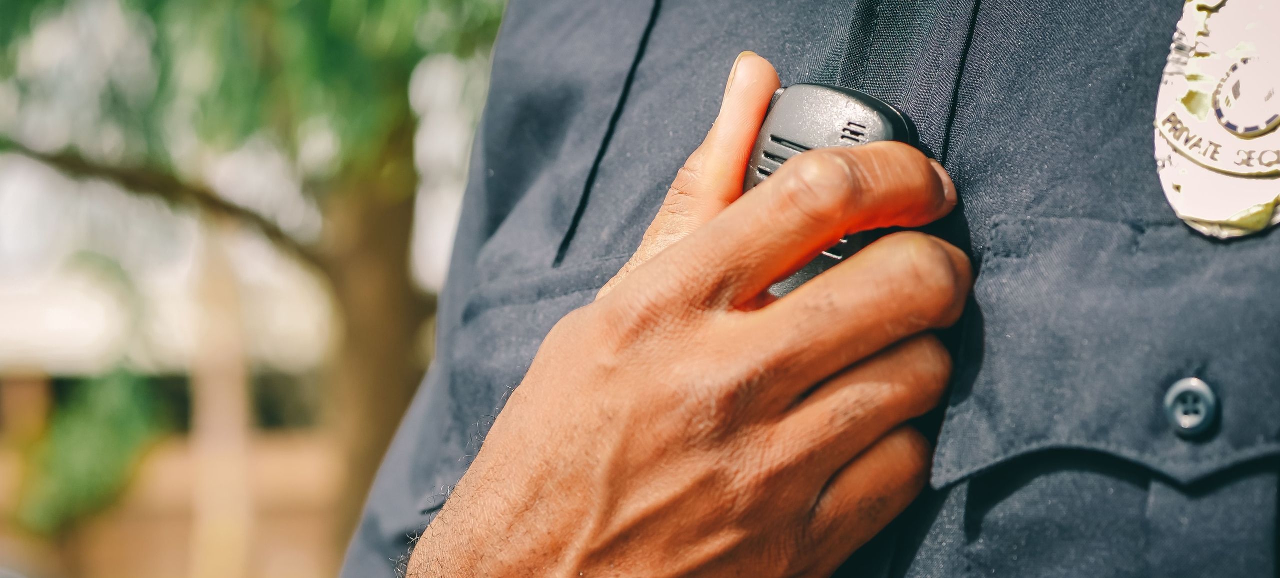 Security guard speaking into a shoulder radio