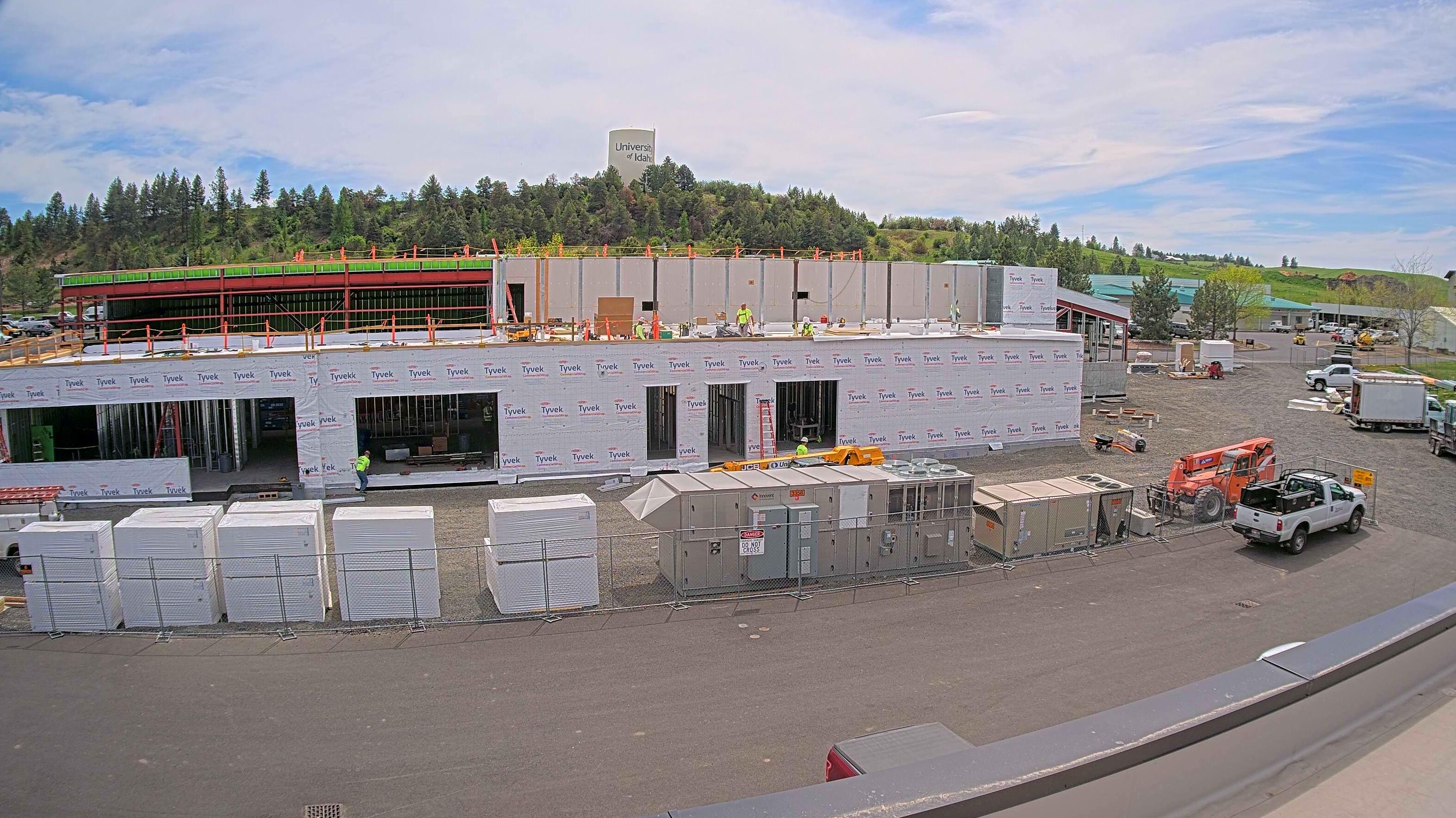 University of Idaho Meat Science and Innovation Center under construction covered in Tyvek Housewrap and materials and a job trailer sitting out captured by a construction camera