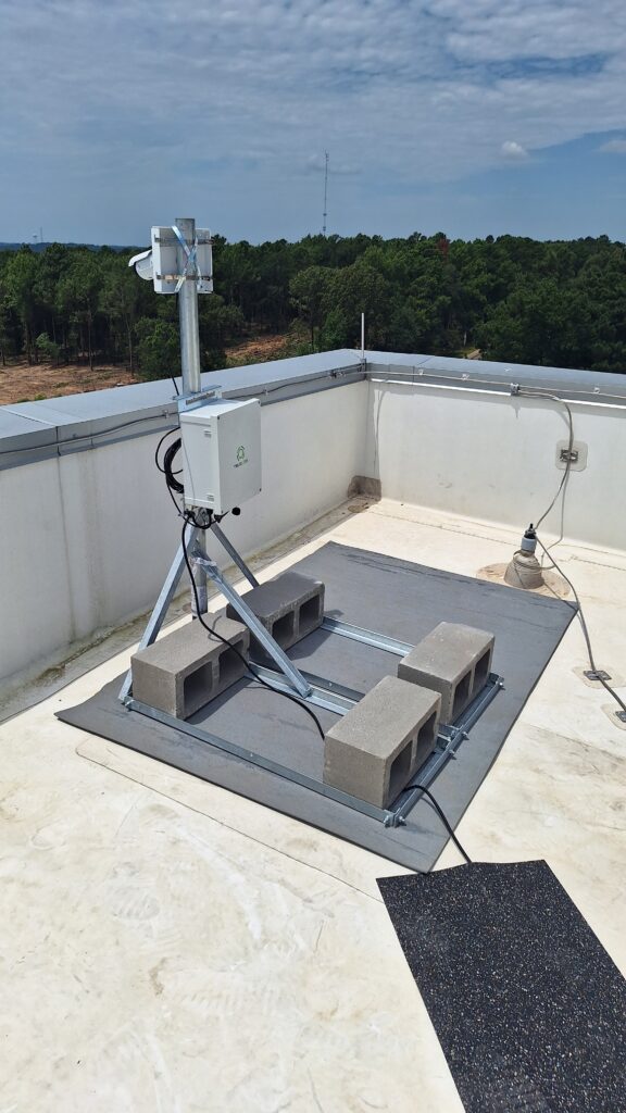 An elevated camera mounted on a rooftop captures an active construction site. This time lapse camera records the project's progress over time, providing a detailed view of the construction activities and site development.