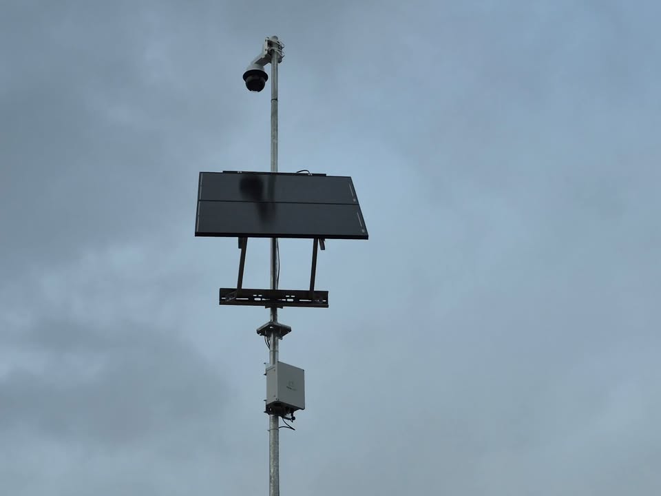 TrueLook solar powered security camera mounted on a pole with solar panel at a jobsite