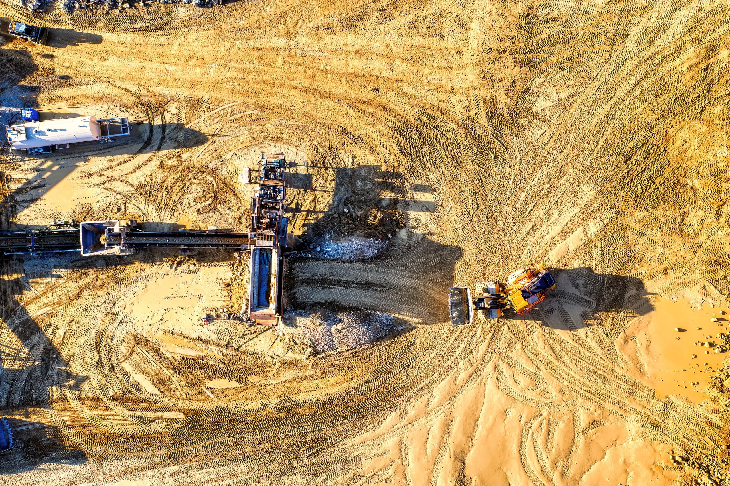 Aerial view of excavation equipment on a sandy site