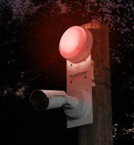TrueDeter security system for construction sites mounted to a wooden pole with a red siren blinking