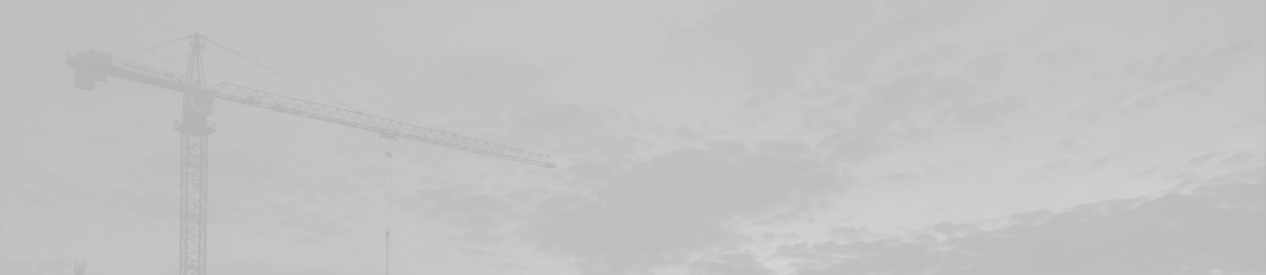 Tower crane against a dark cloudy sky