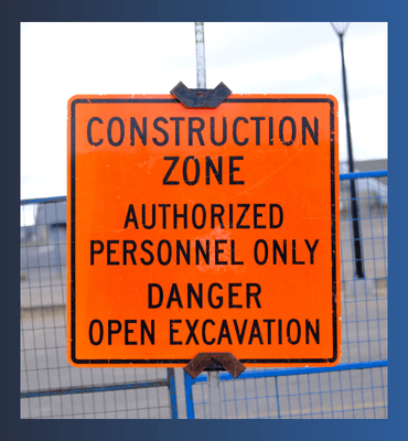 A construction safety sign on a fence on a jobsite to show equipment needed to keep a site safe