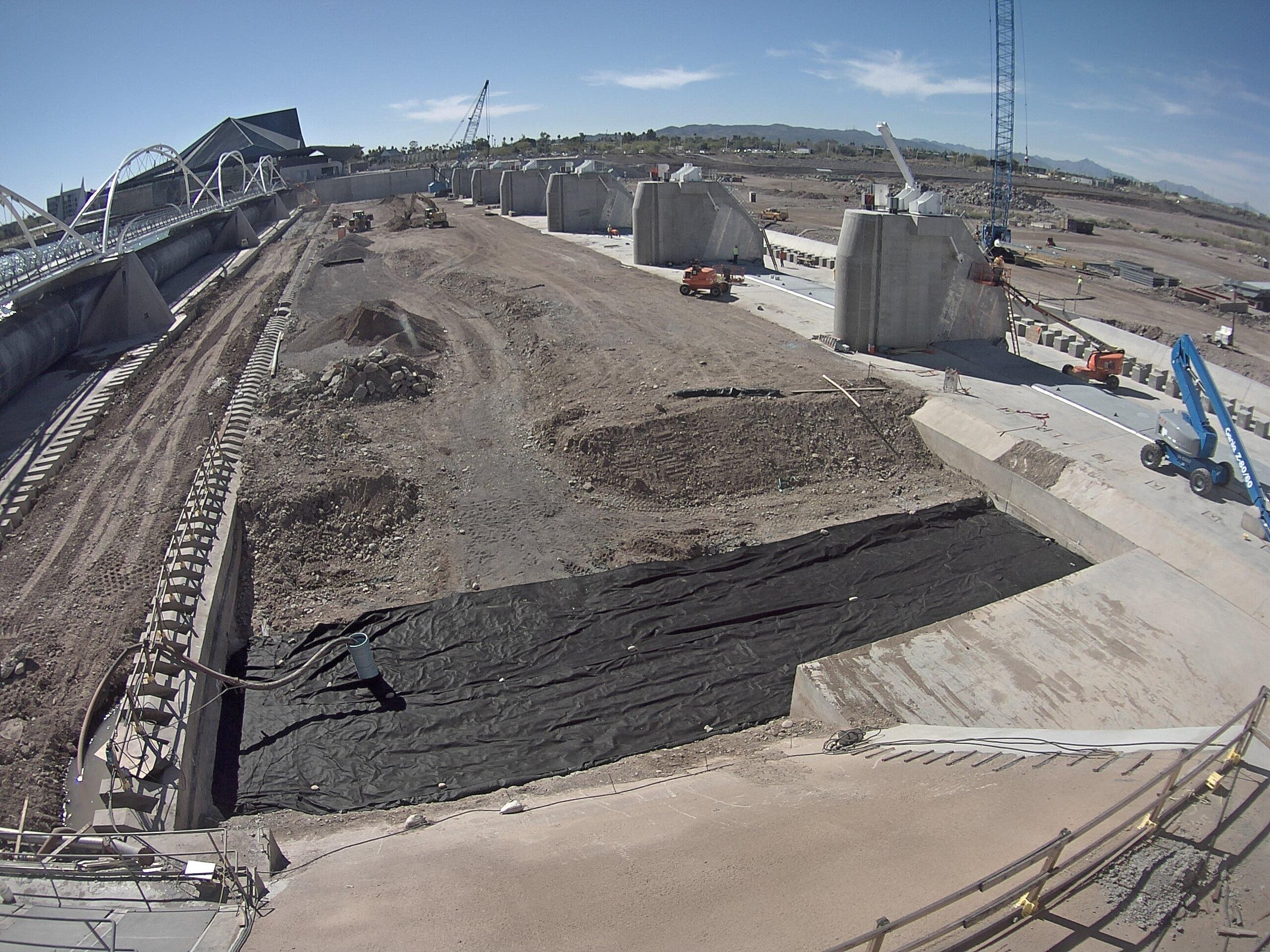 Camera view of a large excavation beside a stadium