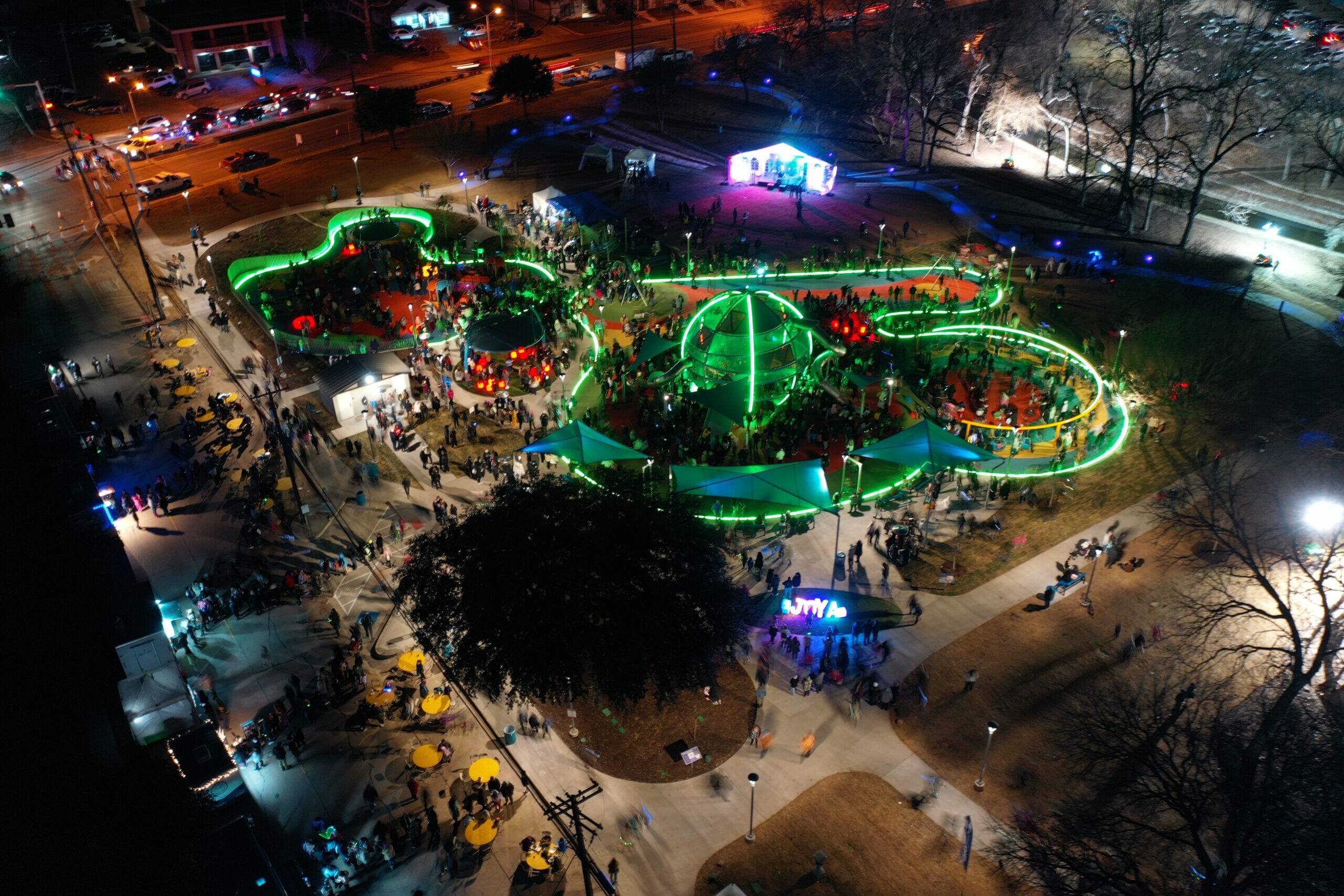 Aerial view of the Joya playground lit green at night