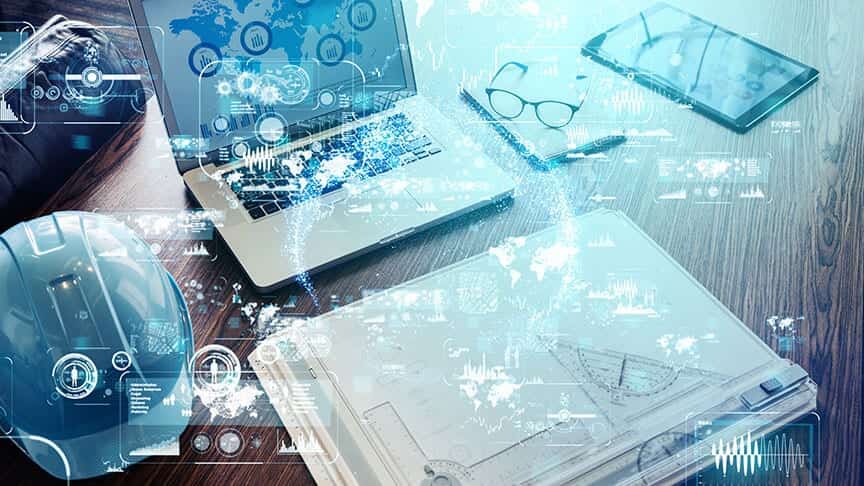 Laptops and tablets with digital overlays on a desk