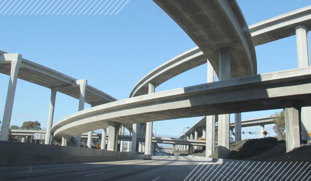 Curved highway overpasses against a blue sky