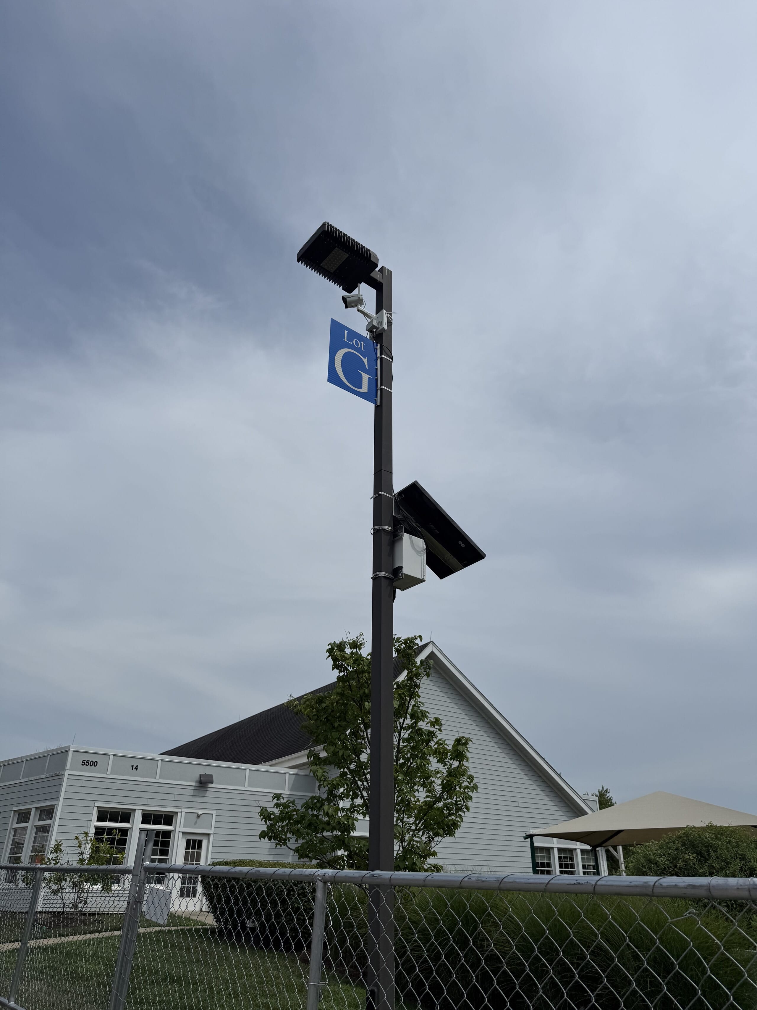 Camera on a light pole beside a building