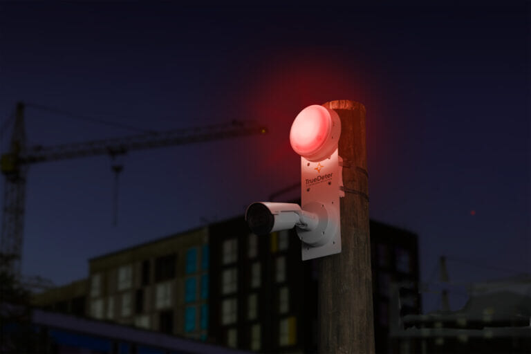 TrueLook's TrueDeter security camera unit on a construction site at night protecting it with a red strobe light