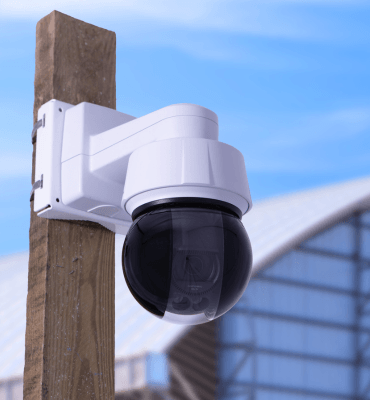 PTZ Camera on a wooden pole watching a construction camera