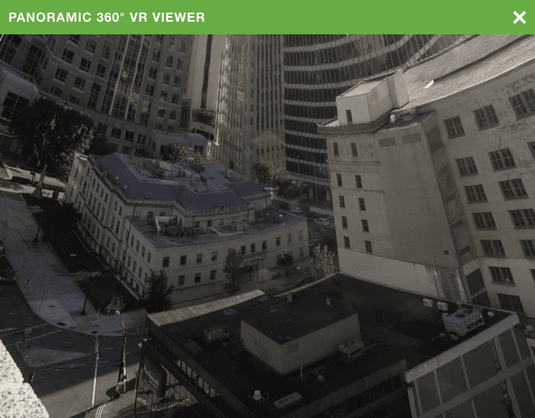Panoramic 360 VR viewer showing a city block from above