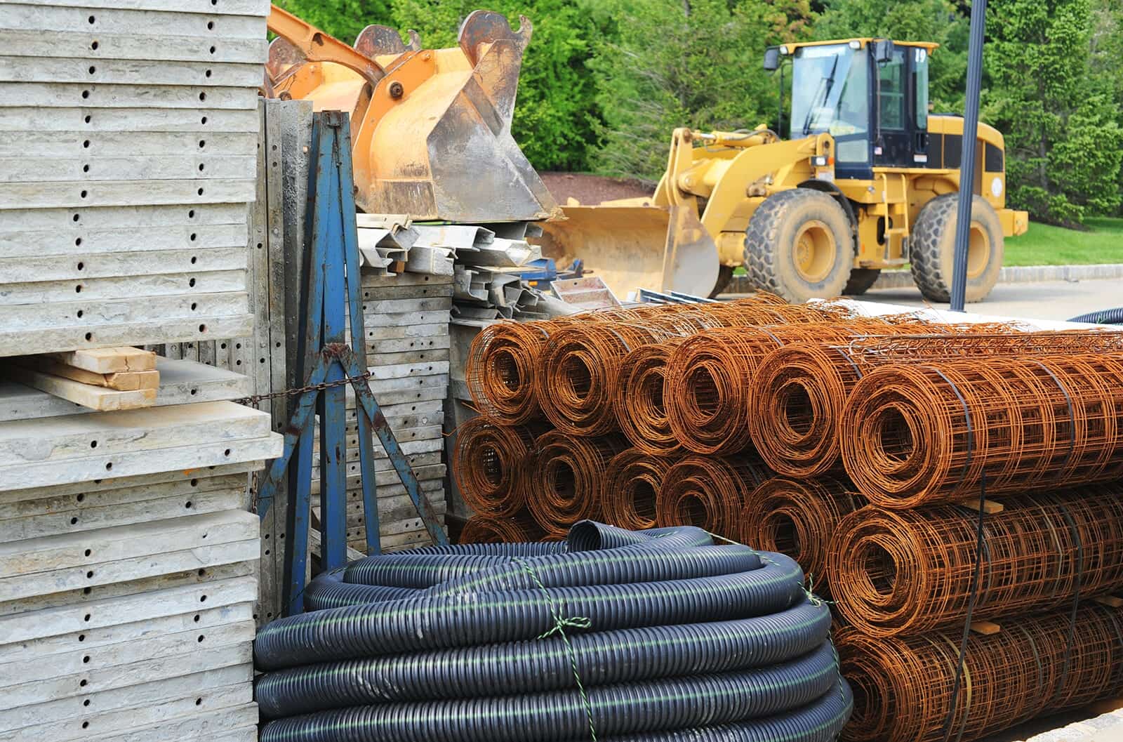Construction supplies stacked beside a wheel loader