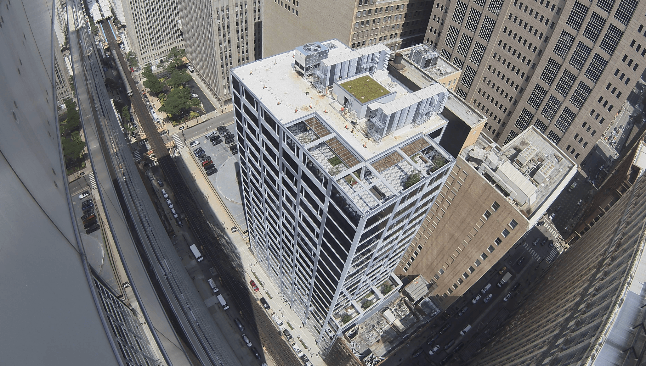 Aerial camera view of a high-rise between city towers