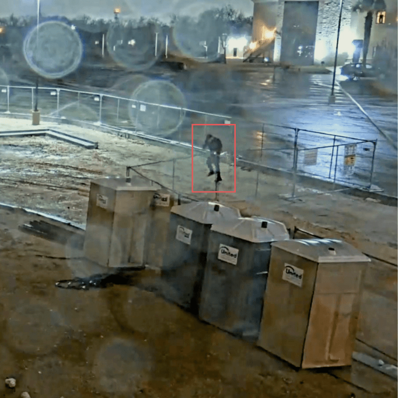 Night camera view of a trespasser flagged in a red box