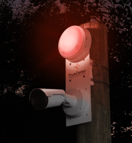 TrueDeter security system for construction sites mounted to a wooden pole with a red siren blinking