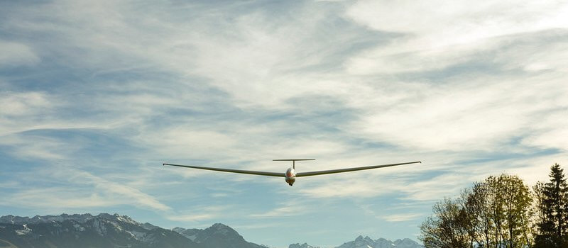 A fixed-wing drone flying through the sky