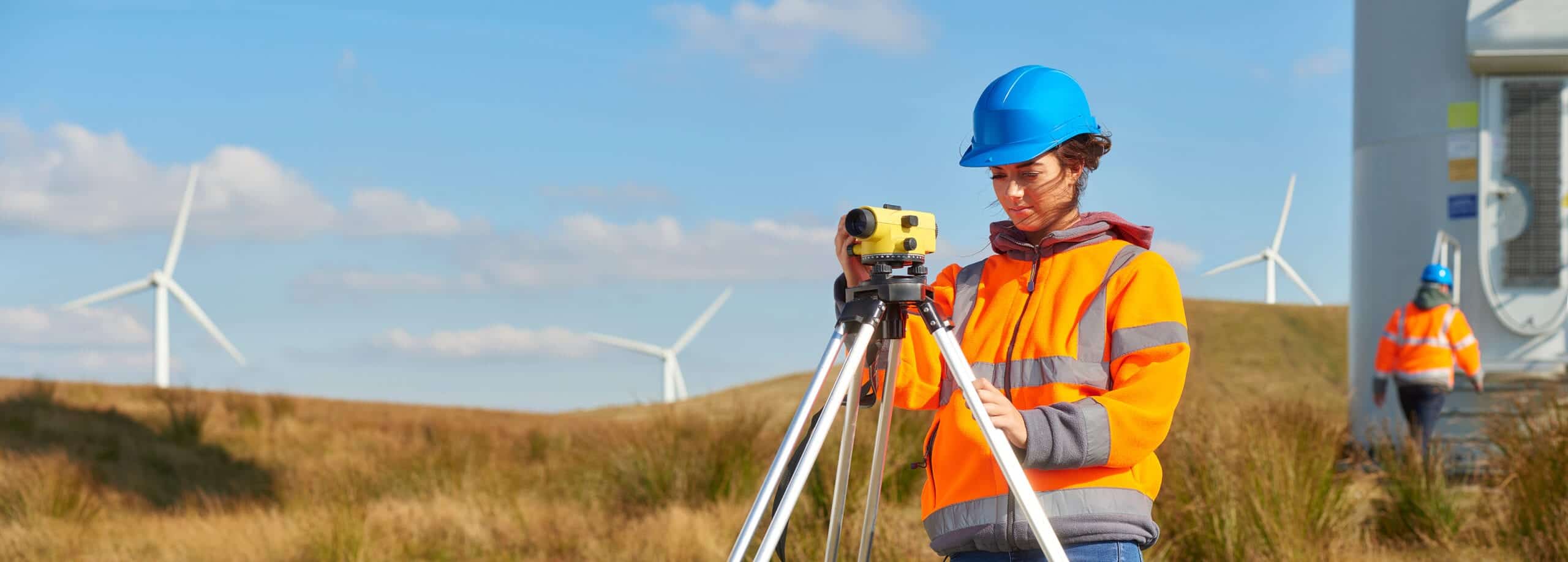 Surveyor with a level at a wind farm
