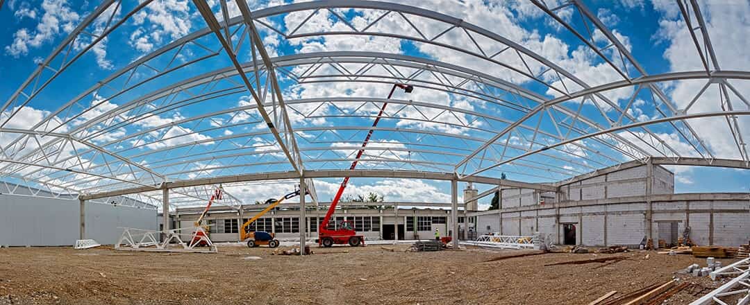 Wide-angle view of a steel roof frame under construction