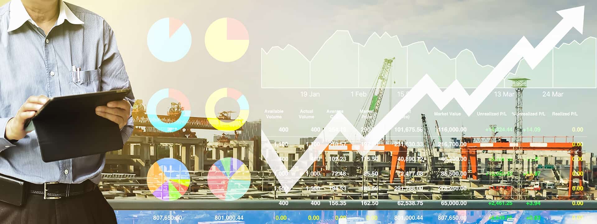 Man with a tablet beside rising financial charts