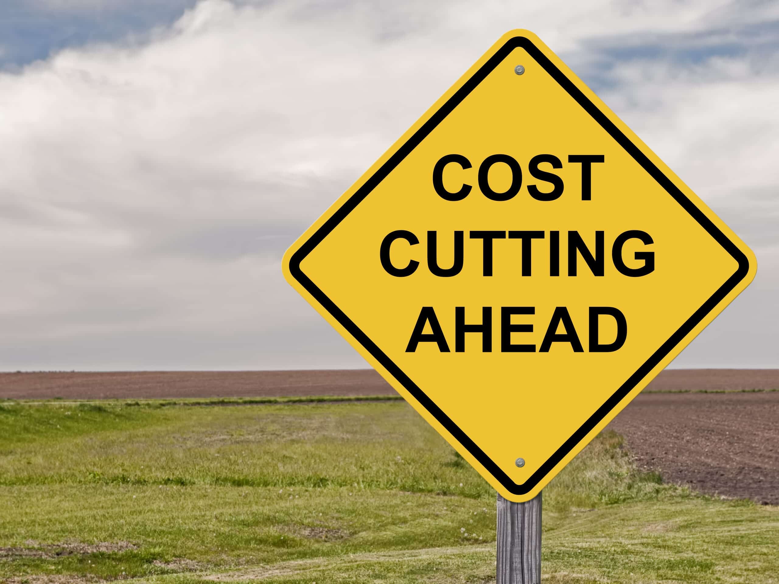 Cost Cutting Ahead road sign in a field