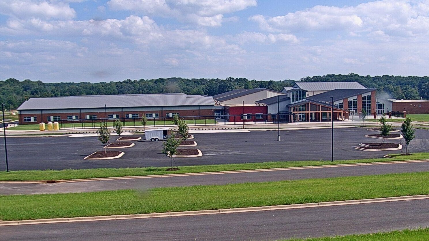 Camera view of a completed school building and parking lot