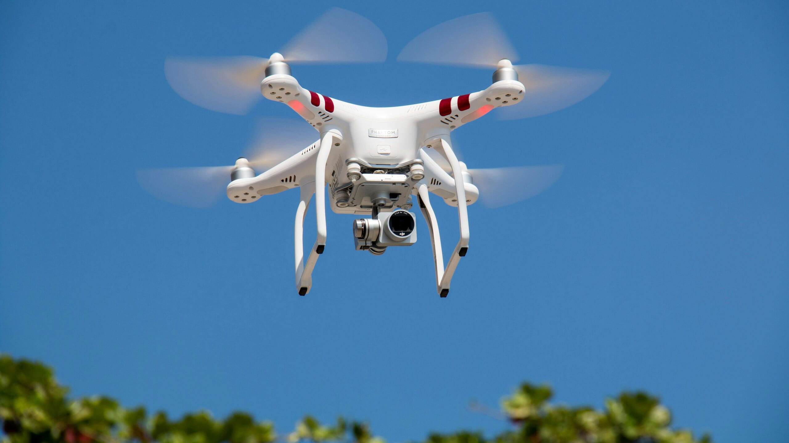 A drone with a camera attached flying in the sky
