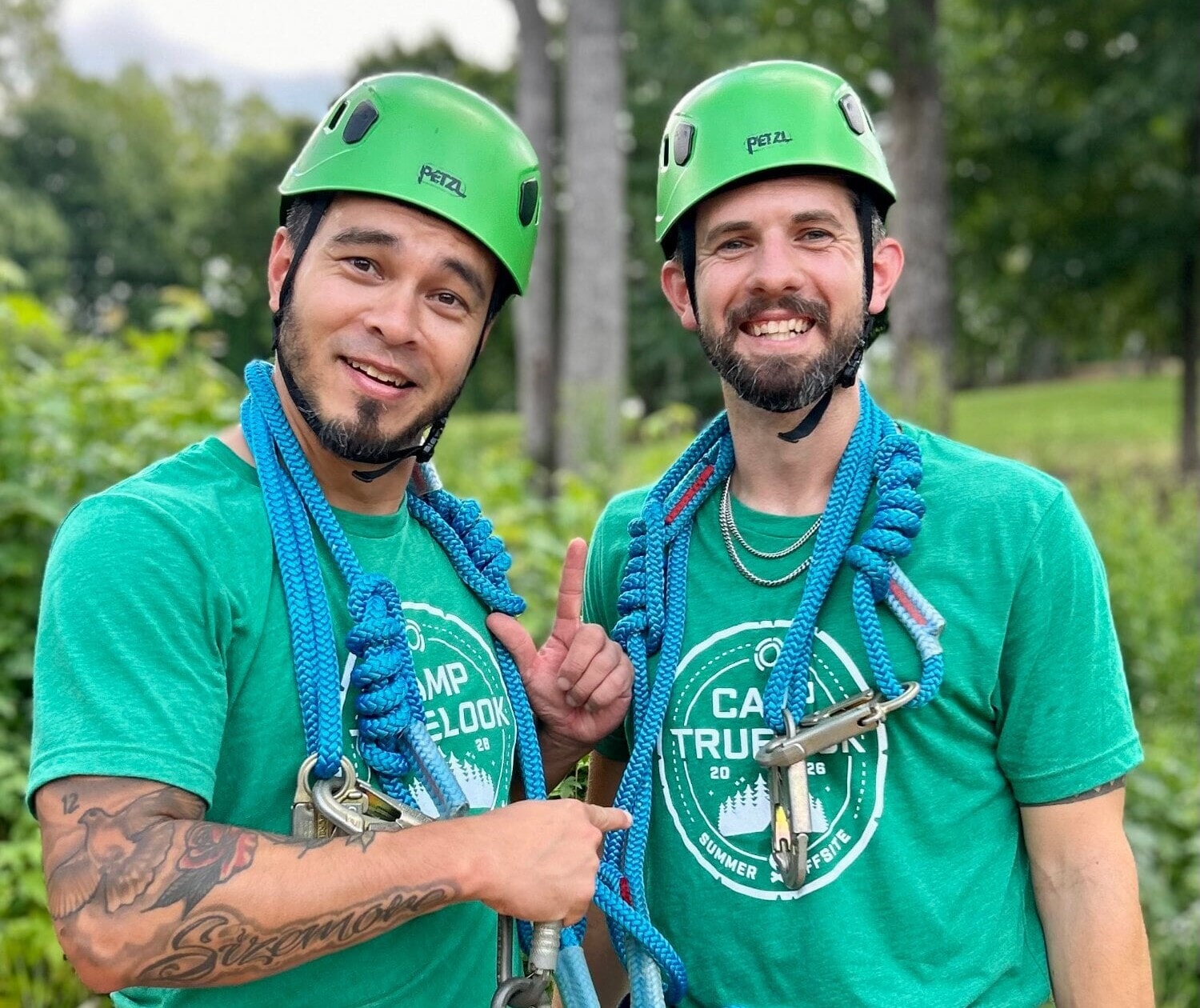 Two TrueLook teammates gearing up for the ropes course at Camp TrueLook