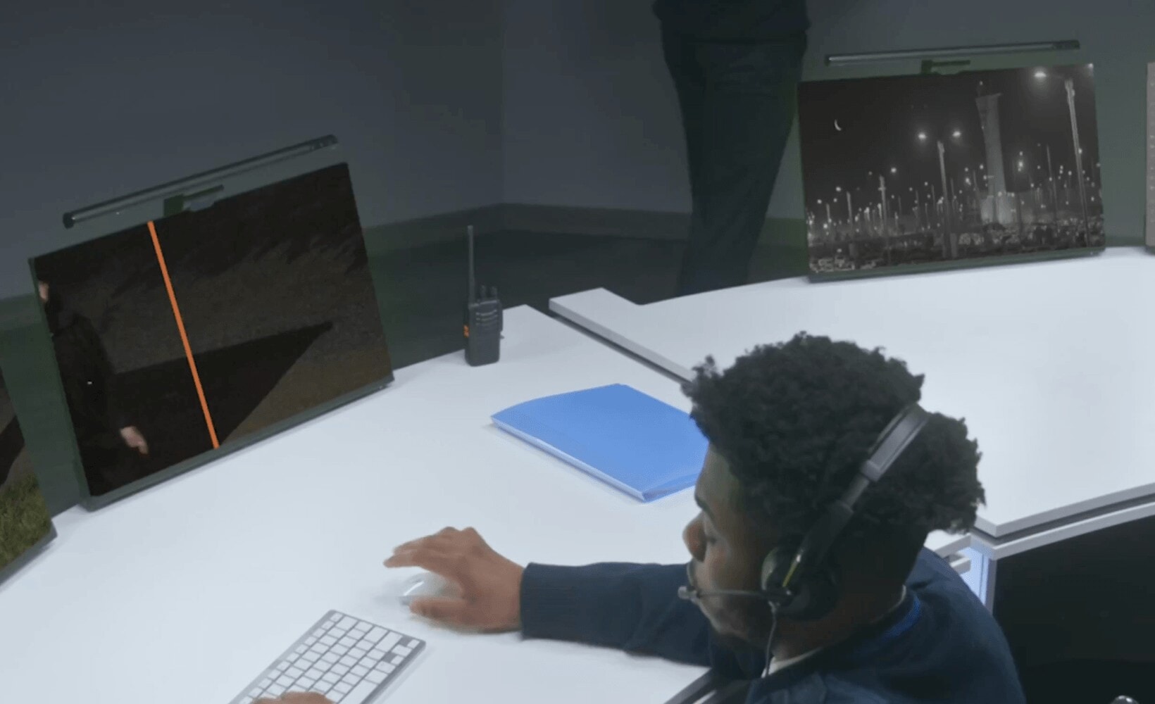 TrueLook monitoring specialist with a headset reviewing jobsite camera feeds