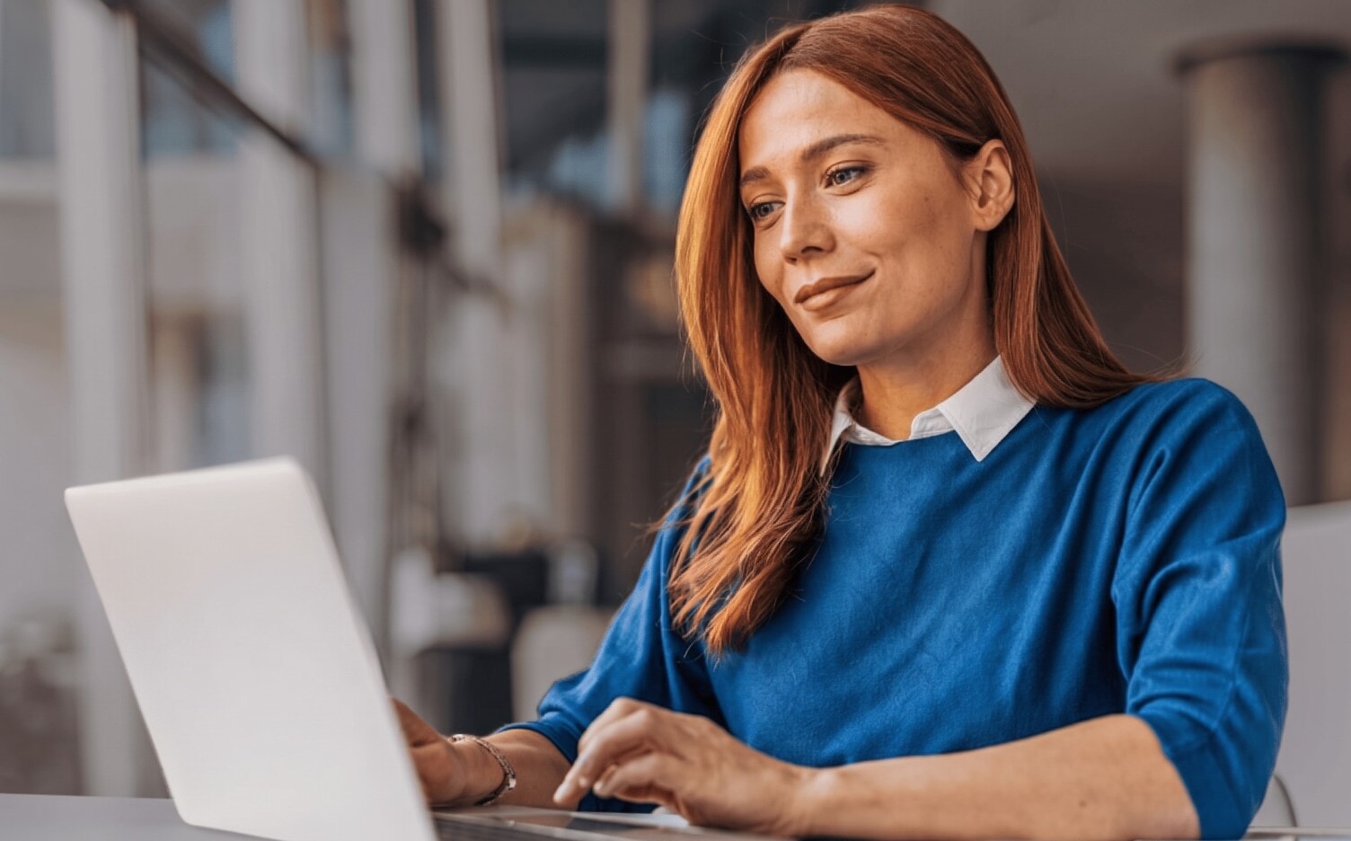 Marketing manager working on a laptop in an office